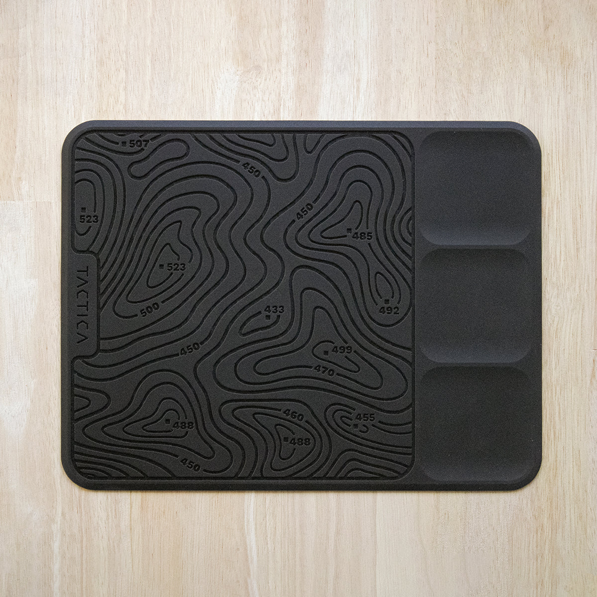 Vertical view of the EDC gear mat showing its gear trays and topo style storage area