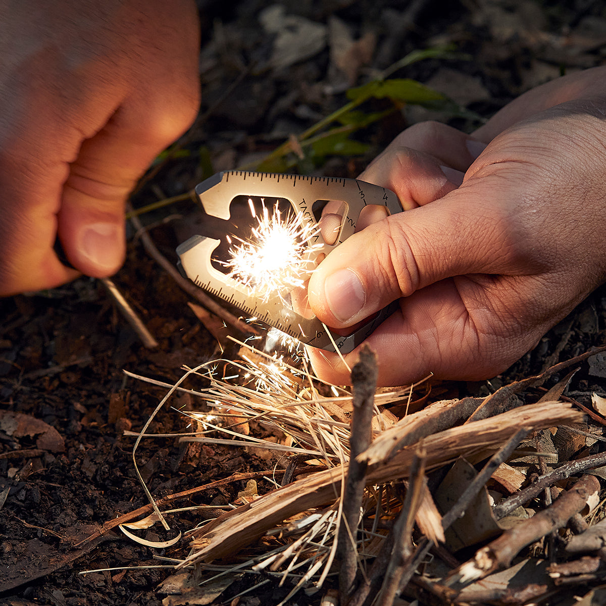 M020 being used to create sparks as a camping tool firestarter