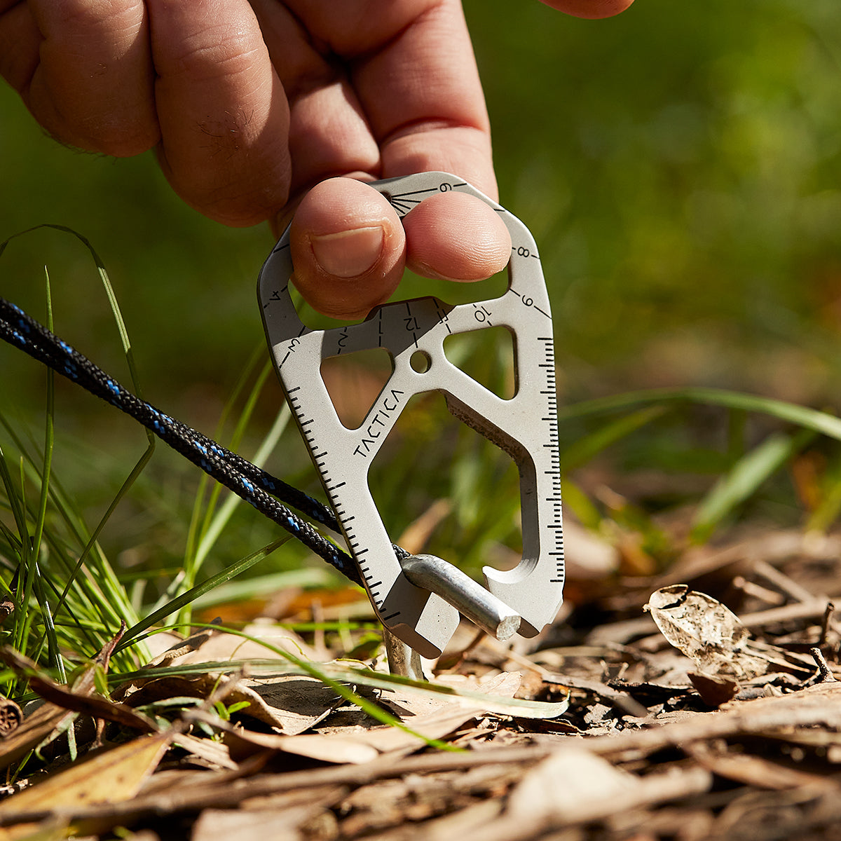 M020 being used as a camping tent peg puller