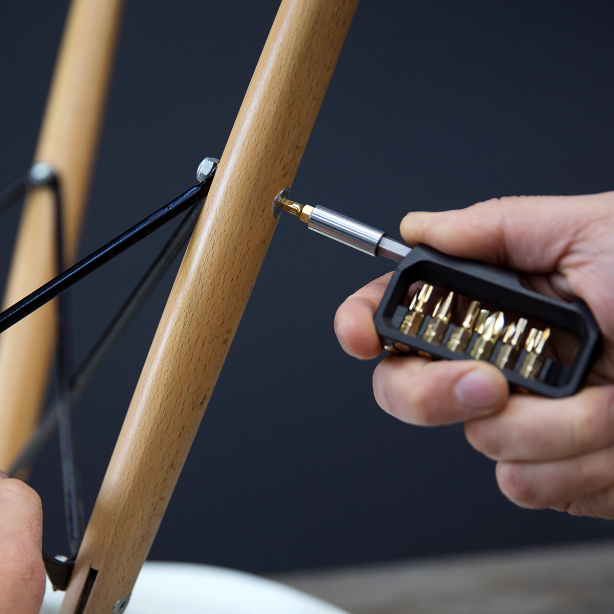 Closeup of a person using the portable extender hex bit screwdriver to tighten a screw